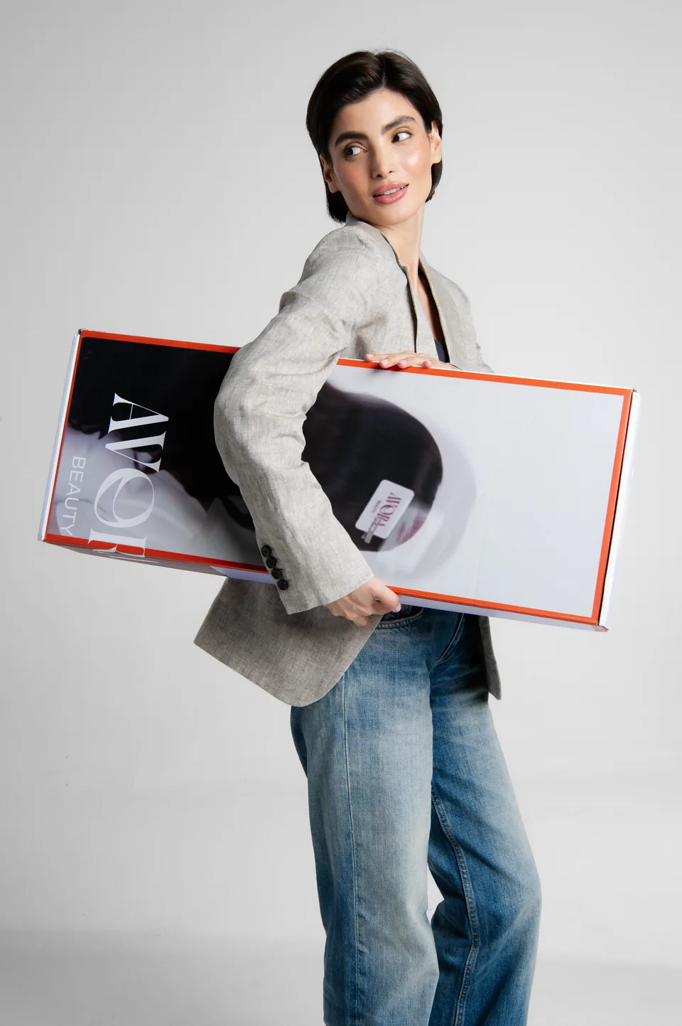 Woman carrying an Avora Beauty box, e-commerce and social content by Alined Creative