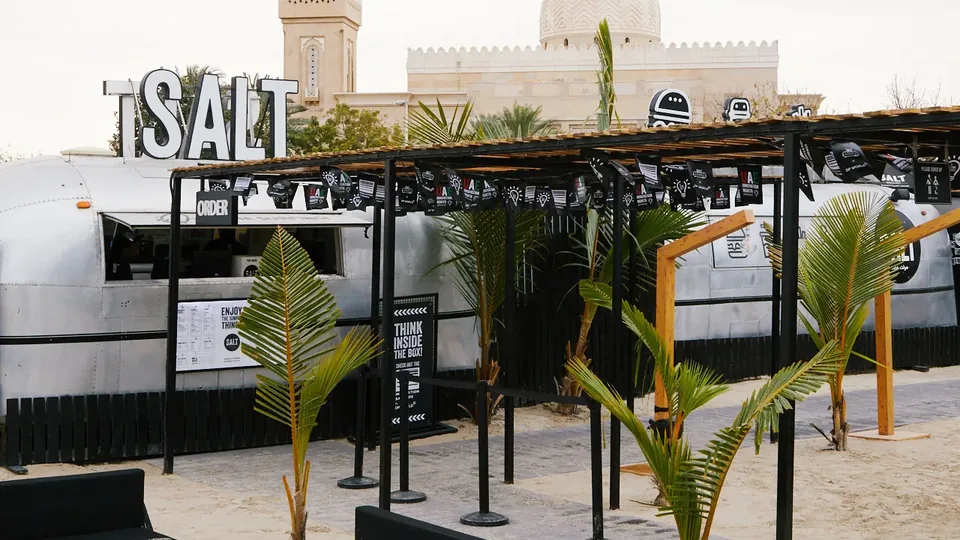 SALT restaurant and food truck with palm trees in Dubai