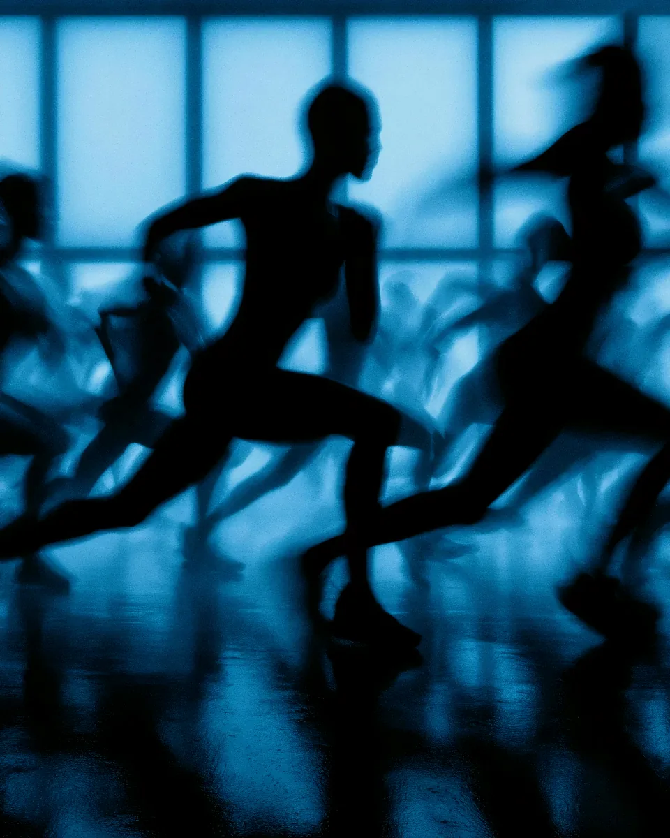 AI-generated silhouettes of runners in blue light