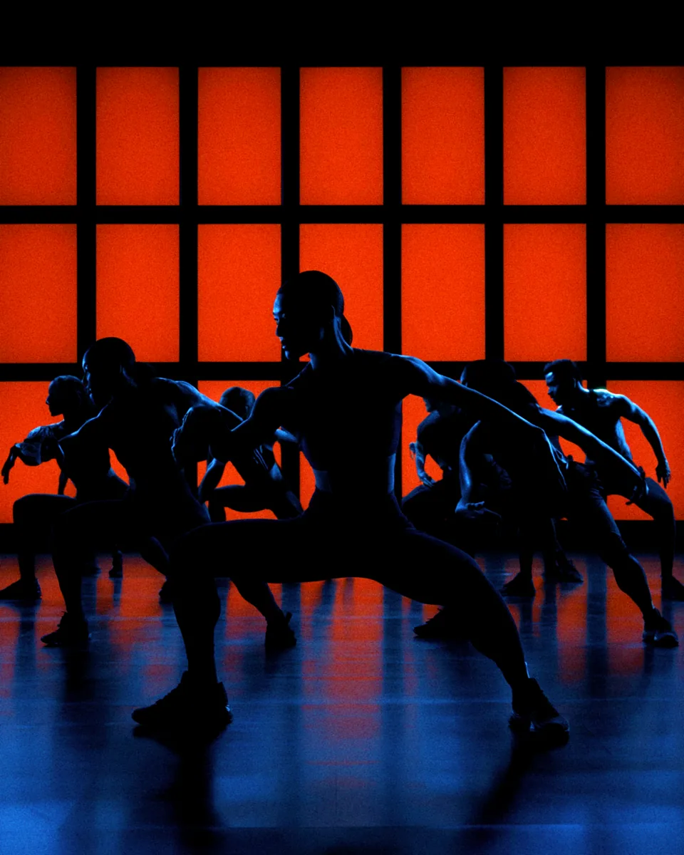 AI-generated silhouettes of dancers against a red and blue stage