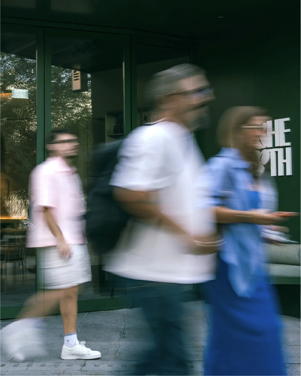 Blurred pedestrians walking past a restaurant, Of The Earth social content