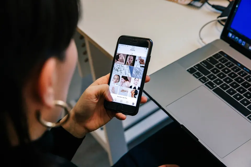 Creator reviewing a mood board on a phone and laptop