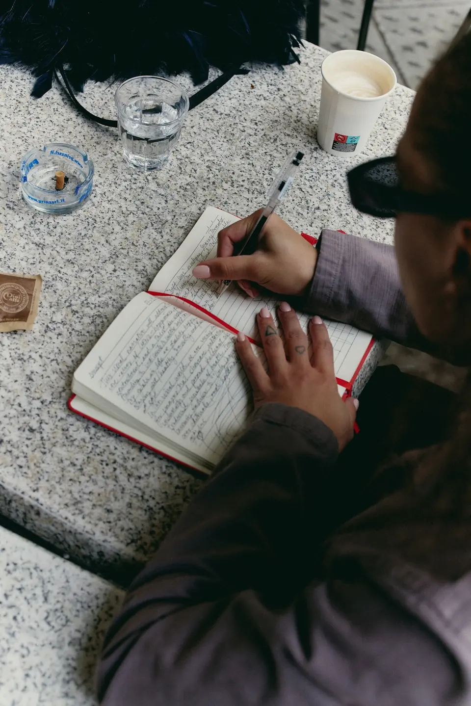 Hand writing brand strategy notes in a notebook