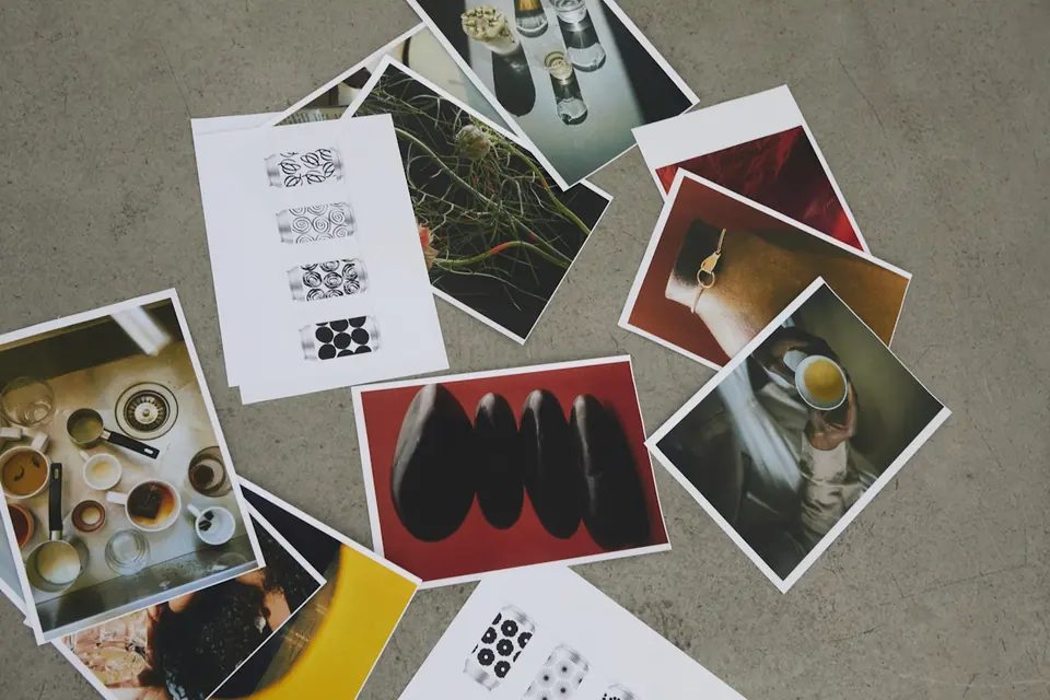 Printed photos and brand references spread on a table